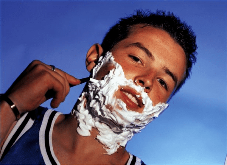 A teenager shaves and thinks about penis enlargement