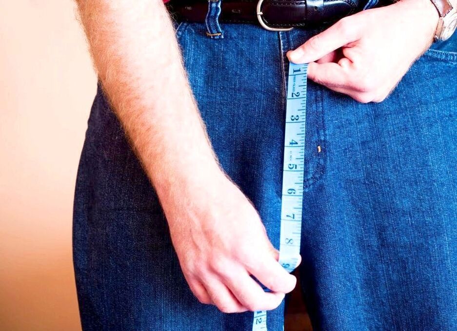 A man measures his penis after enlargement